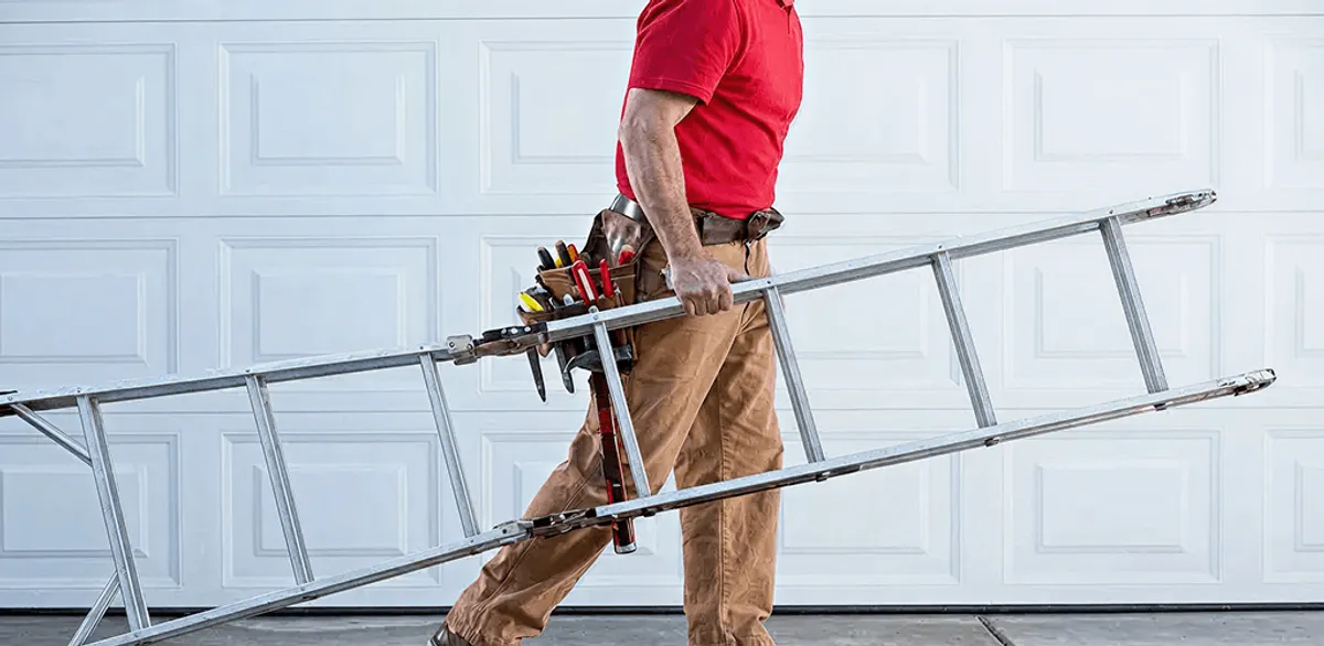 Garage door repair technician arriving with tools and ladder in Raleigh, NC
